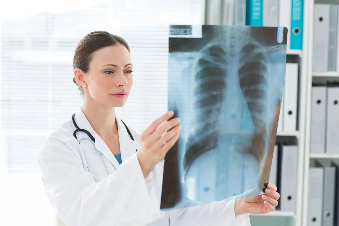 A doctor looking at an x-ray of something